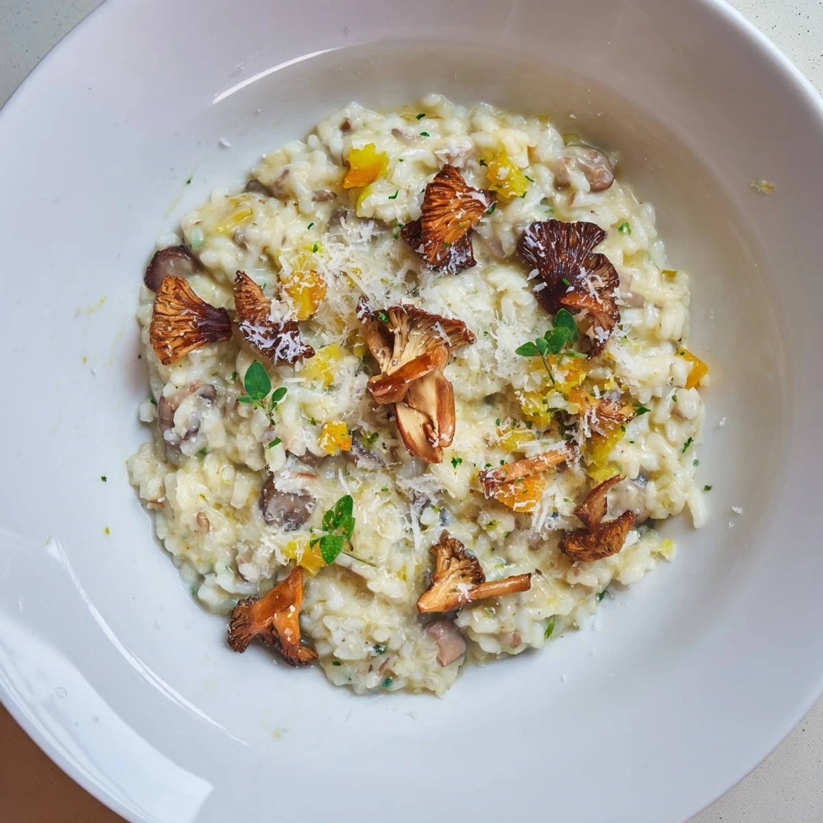 Enjoy this comforting bowl of Cedar-Warm Mushroom and Thyme Risotto, showcasing the dish's creamy texture.