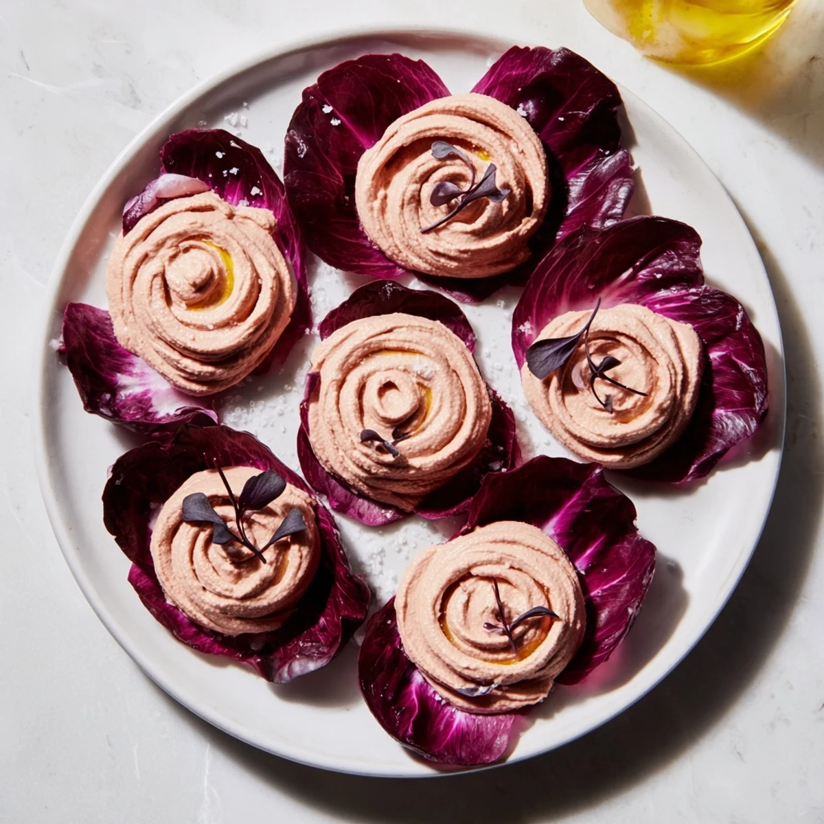 Vibrant The Velvet Rose appetizer showcases beet hummus swirled into elegant rose shapes, ready to enjoy.
