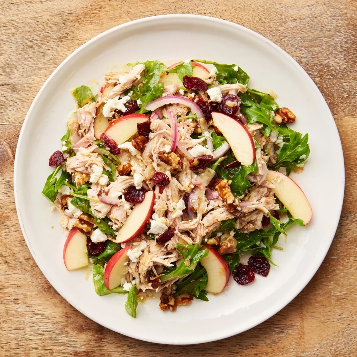 The vibrant Chicken and Apple Winter Salad is piled high, a perfect flavorful lunch or dinner option.