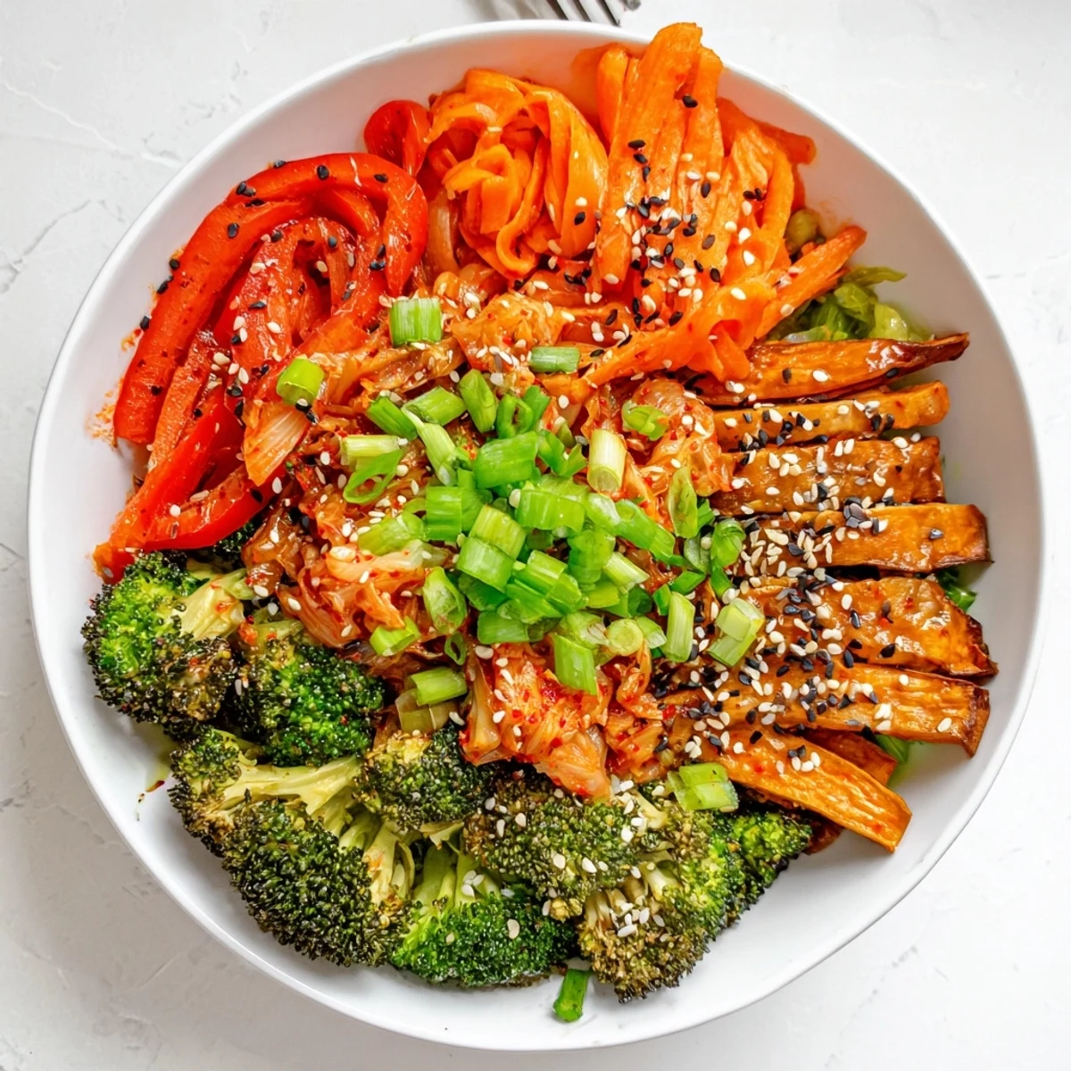 Vibrant bowl of Comforting Fermented Veggie Winter Stir-Fry, featuring crisp broccoli, sweet potato matchsticks, and bright red cabbage tossed in a sesame-soy glaze.
