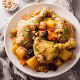 Golden chicken pieces and sweet potatoes are shown in this slow-cooker Soft Spice Tagine.