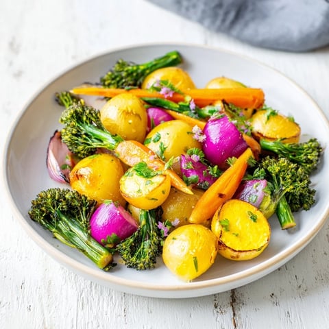 Golden roasted light herb and fern-inspired vegetable platter, tossed with fresh herbs, ready to serve warm.