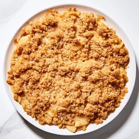 Warm, bubbly spiced apple crisp with a golden crumb topping, perfect for dessert tonight.