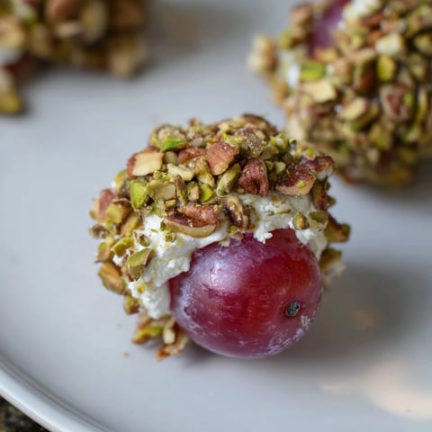 Sparkling grape cluster appetizer, an elegant party starter with cheese-coated grapes and toasted nuts.