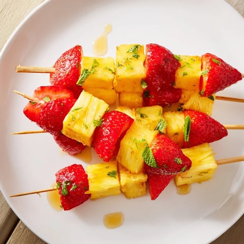 Vibrant fruit skewers with juicy pineapple and sweet strawberries, ready for a healthy snack.