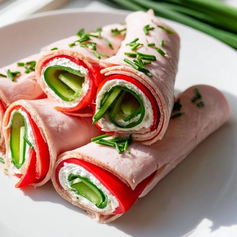 Vibrant photo shows layered Turkey Roll-Ups, showcasing savory turkey and colorful bell peppers.