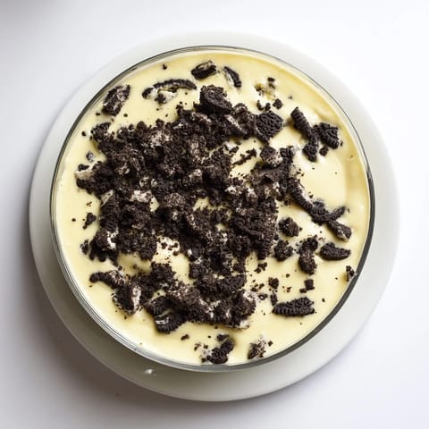 A close-up of creamy vanilla pudding with crushed Oreos, a simple, delicious dessert.