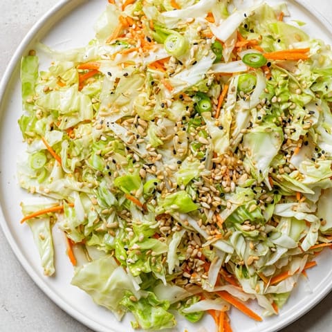 Freshly assembled Cabbage-Core Slaw Salad, a vegan delight with a light, flavorful sesame-ginger dressing.