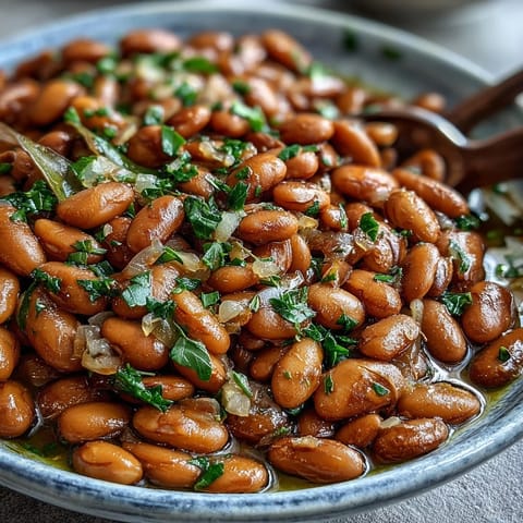 Creamy tender pinto beans seasoned with bay leaves, perfect for a warm vegan side dish or homemade chili base.