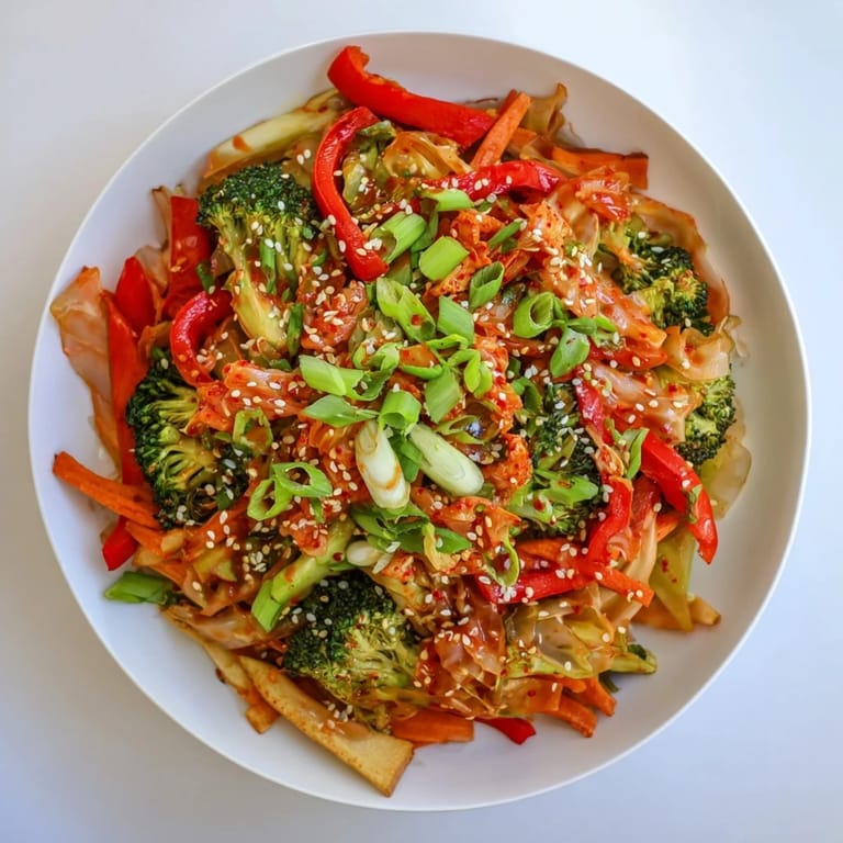 Steaming hot Comforting Fermented Veggie Winter Stir-Fry served over fluffy white rice, topped with spicy chopped kimchi, sliced green onions, and a sprinkle of toasted sesame seeds.